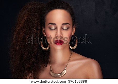 Fashion photo of beautiful elegant african american woman. Girl posing in jewelry, wearing fashionable earrings and necklace. Beauty portrait. Studio shot.