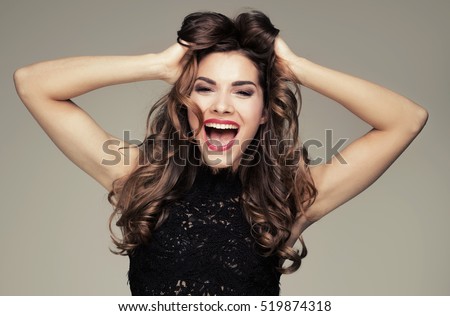 Beautiful brunette woman with amazing toothy smile. Emotions. Happiness. Studio shot.