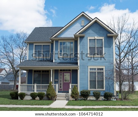Blue Two Story House with Purple Door