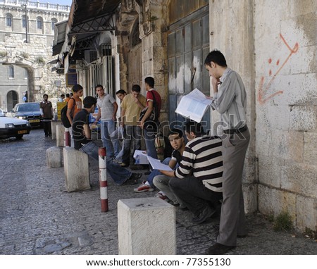 JERUSALEM – JUNE 12: Group of young, male, Arab students stand inside the New Gate on Bab El-Jadid Street in Old City, Jerusalem, Israel, studying for their final graduation exams on June 12, 2007.