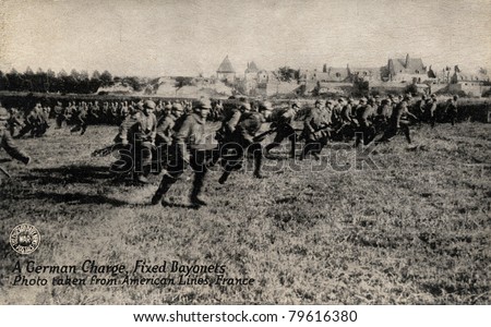 A German Charge, Fixed Bayonet - Early 1900\'s WWI postcard depicting American soldiers on front lines charging Germans with bayonets while in France.
