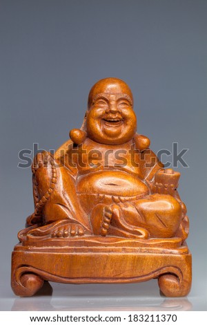 wooden statue of a seated Buddha on a wooden stand