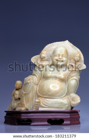 Buddha statue is made of marble statues of children on a wooden stand
