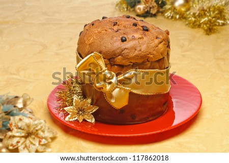 Panettone, typical Christmas cake on red dish