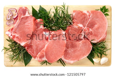 Pork chops on wooden board