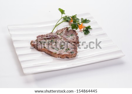 Pork chop on white dish