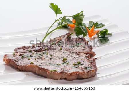 Pork chop on white dish