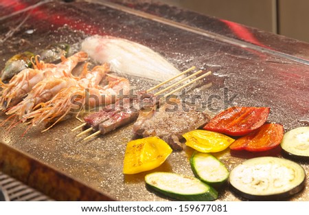 Fish, meat and vegetables on the plate