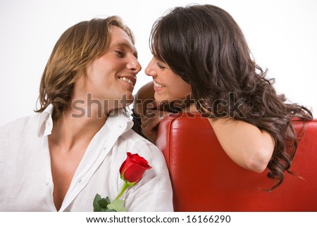 Madly in love man gives a red rose to his beloved