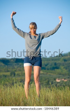 Sporty young woman with upper arms in the hills