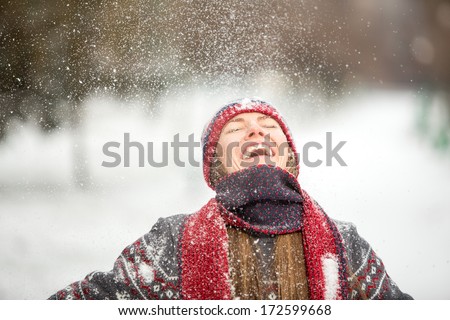Winter fun woman playful during winter holidays vacation outside in snow forest. Romantic young woman enjoy snowfall with closed eyes