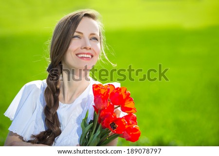 Portrait of young beautiful woman with flowers happy smiling, enjoy nature over green background summer nature
