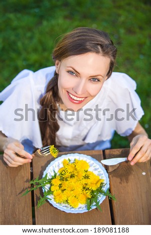 Funny woman eating vegetables salad. Dieting concept. Healthy food. View from above focus on face