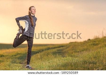 Fitness woman runner relaxing after outdoor running and working out. An attractive female runner stretching before workout