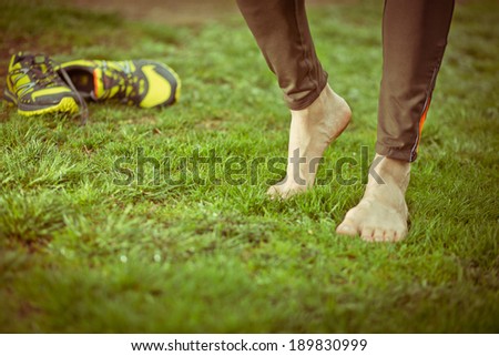 Athlete relaxing after running sport feet. toned image