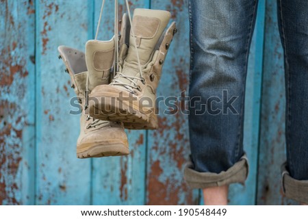 Man in jeans with his shoes over grunge blue wooden background. focus on nose shoe