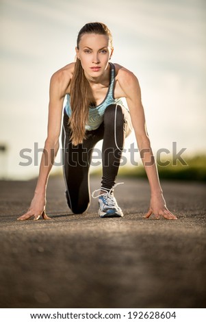 Running woman. Young woman jogging outdoors on auto road. Sport woman starting running. backlight