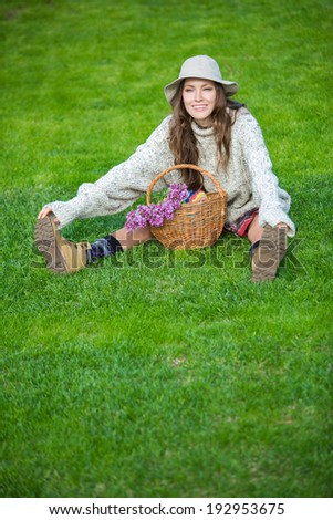Enjoyment - free happy woman enjoying nature sitting in park on a lawn. soft daylight, copy space