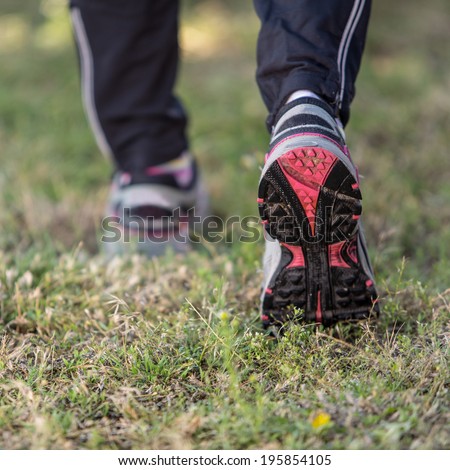 Runner feet running cross country. Shoe close-up