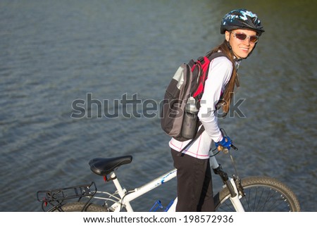 Cyclist riding the bike on the beautiful spring mountain and lake trail. daylight