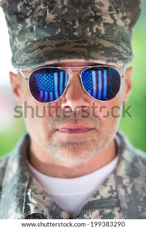 Portrait of us army man with american flag reflection in the sunglasses
