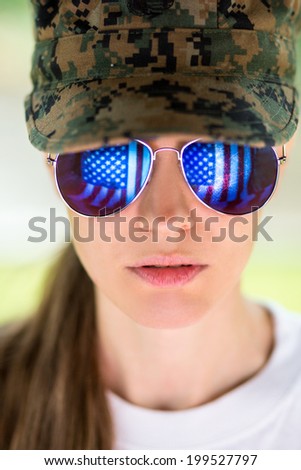 Military female wearing cap and sunglasses