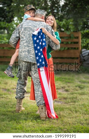 Happy family reunited, father in military uniform returns home . Us happy family portrait. focus on man