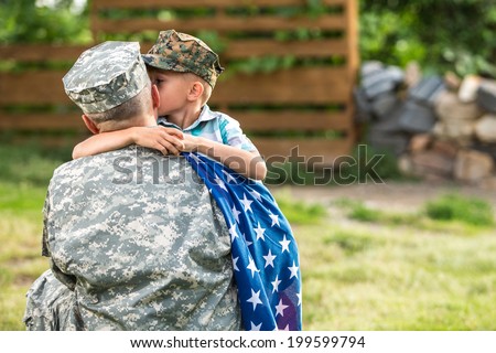 Military man father hugs son. Portrait of happy american family. focus on father back