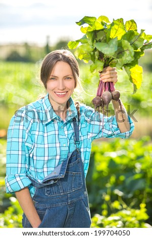 Gardening, cultivation - beautiful happy woman and organically grown beetroots