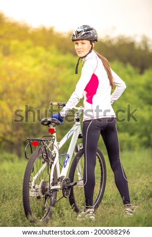 Young woman cycling outdoors on a sunny day