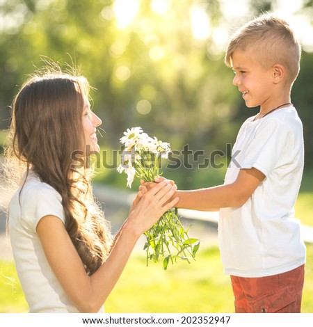 Little boy give flower present to her mother. focus on boy