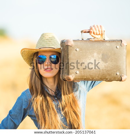 Woman with suitcase. Fashion woman holding old suitcase. focus on bag