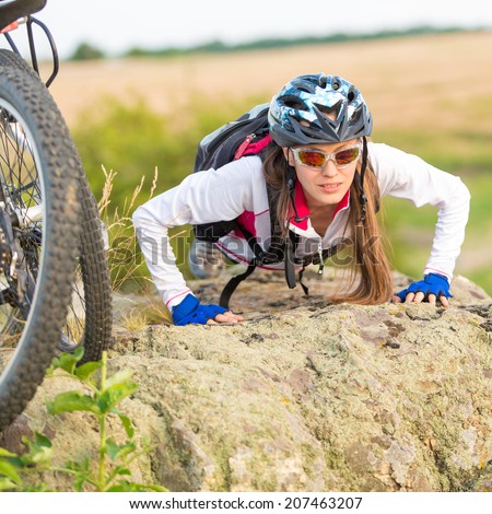 Sport bike woman on cliff exercising portrait next to bike