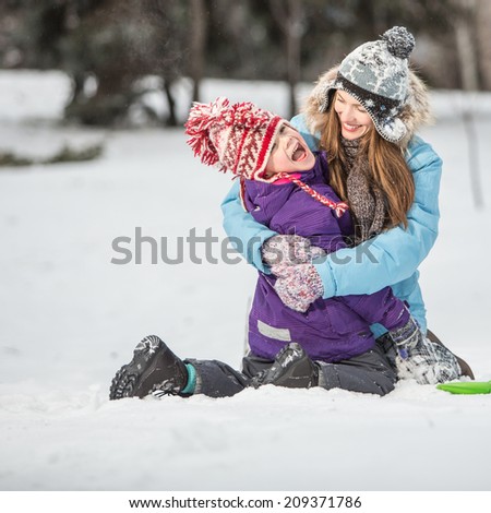 Winter fun, winter vacation concept. Happy mother and son in winter park having fun. focus on mother
