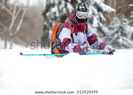 Winter tourism, winter fun, snow, winter travel - young woman traveling hiking in stormy snow weather. Active outdoor sport lifestyle