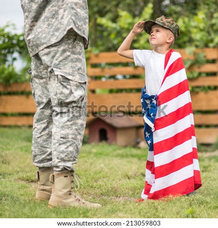 USA patriots concept. Son salutes his father. focus on son. daylight