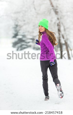 Winter running woman in snowy winter morning. motion, soft daylight