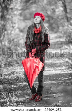 Black and white autumn woman with red umbrella