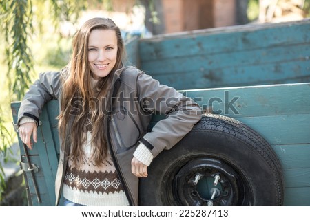 Young farmer with agricultural trailer