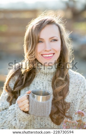 Joyful young woman drink tea happy smiling