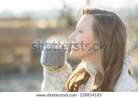 beautiful woman drinking coffee and looking sideways happy smiling  enjoy the life