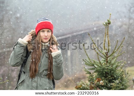 Young traveler enjoy the freshness of winter nature and first snow. copy space