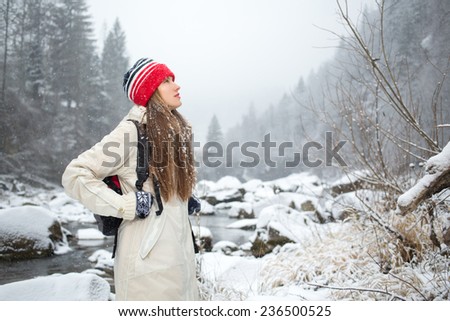 Hiking woman in mountains. Fitness and healthy lifestyle outdoors in winter nature