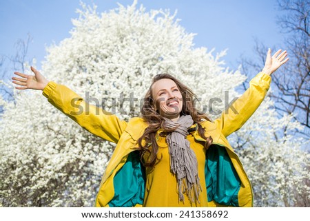 Young woman enjoy the freshness of the spring days with hands outstretched