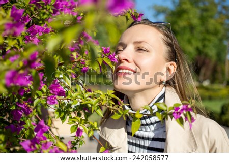 Smell of spring. Portrait of beautiful woman in spring garden enjoy nature