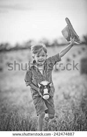 Boy running on field. black and white image, motion, vignette