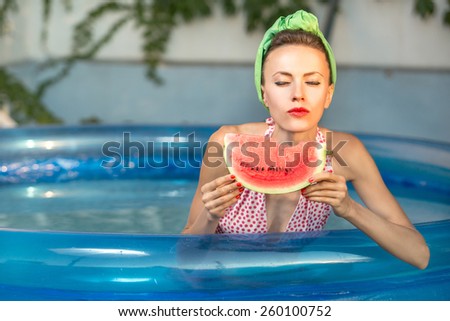 Beauty model with watermelon enjoy her vacation in swimming pool. Pinup style