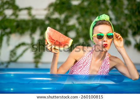 Beauty model with watermelon enjoy her vacation in swimming pool. Pinup style