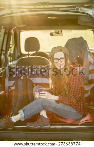 Vacation, travel - woman travel by car. baclkight, sunshine. grain added