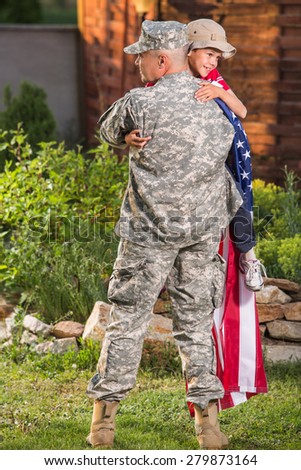 Military man father hugs son. Portrait of happy american family